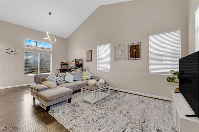 3659 Gerri Bay Ln, Las Vegas, NV 89147 - living area with high vaulted ceiling, baseboards, wood finished floors, plenty of natural light, and a chandelier