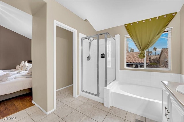 3659 Gerri Bay Ln, Las Vegas, NV 89147 - ensuite bathroom featuring a shower stall, tile patterned flooring, a garden tub, vanity, and vaulted ceiling
