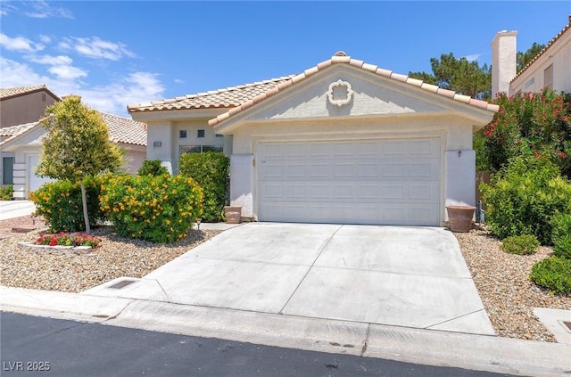 8312 Raphael Ct, Las Vegas, NV 89129 - mediterranean / spanish house featuring a tiled roof, concrete driveway, and stucco siding