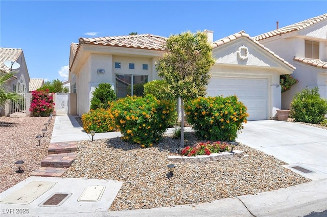 8312 Raphael Ct, Las Vegas, NV 89129 - mediterranean / spanish-style house with a tiled roof, stucco siding, a garage, and concrete driveway