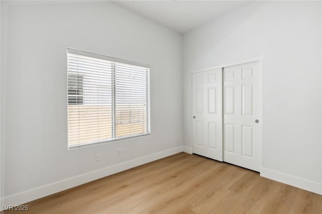 8312 Raphael Ct, Las Vegas, NV 89129 - unfurnished bedroom with baseboards, light wood finished floors, and a closet