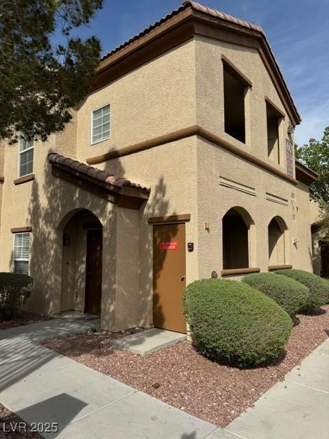 10290 Gilmore Canyon Ct Unit 103, Las Vegas, NV 89129 - view of front facade featuring stucco siding and a tile roof