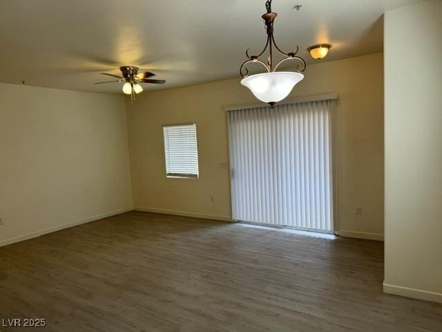 10290 Gilmore Canyon Ct Unit 103, Las Vegas, NV 89129 - unfurnished room featuring a ceiling fan, wood finished floors, and baseboards