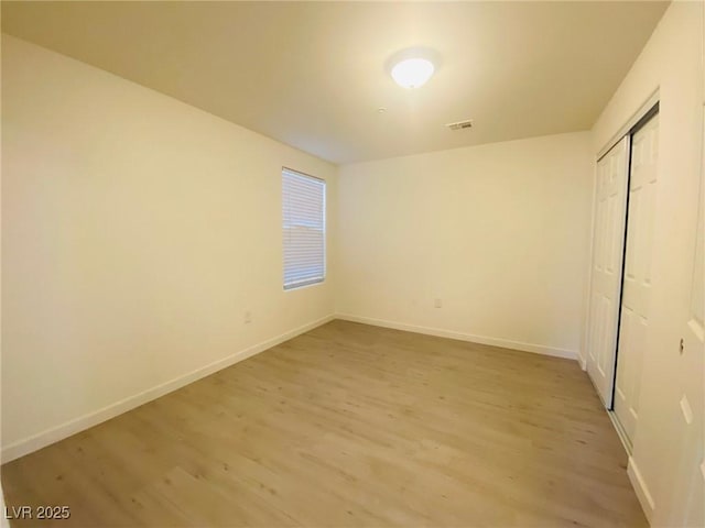 10290 Gilmore Canyon Ct Unit 103, Las Vegas, NV 89129 - unfurnished bedroom featuring light wood-style floors, a closet, and baseboards