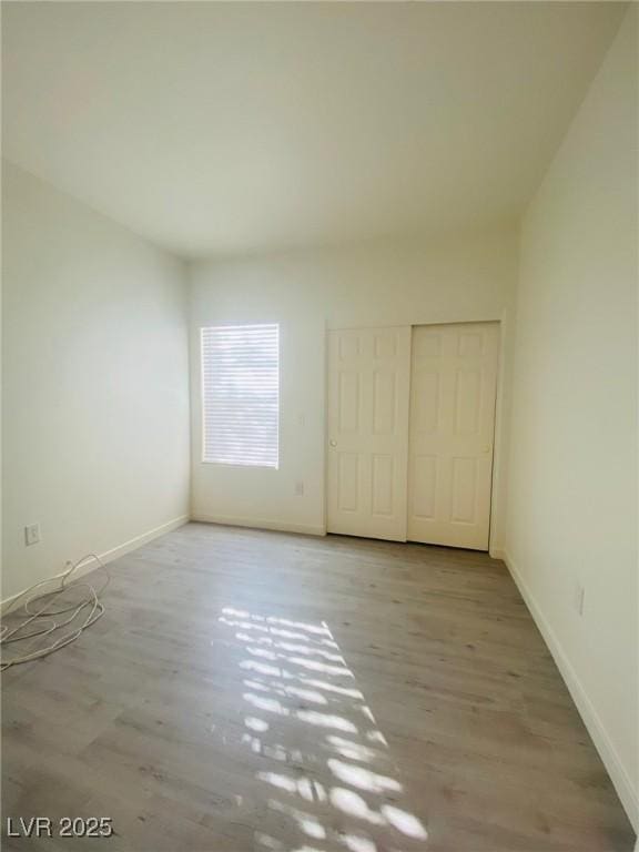 10290 Gilmore Canyon Ct Unit 103, Las Vegas, NV 89129 - unfurnished bedroom featuring wood finished floors, baseboards, and a closet