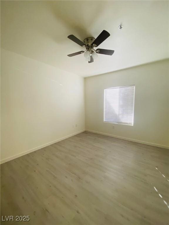 10290 Gilmore Canyon Ct Unit 103, Las Vegas, NV 89129 - empty room featuring wood finished floors, ceiling fan, and baseboards