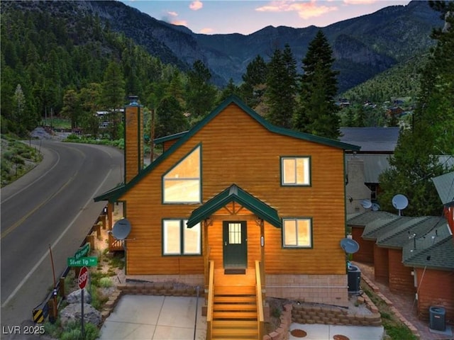 4830 Silver Tip Way, Mount Charleston, NV 89124 - view of front facade with a chimney, a mountain view, and cooling unit