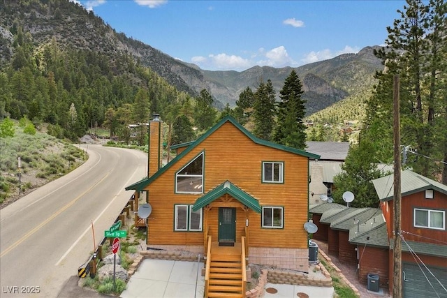 4830 Silver Tip Way, Mount Charleston, NV 89124 - chalet / cabin with a chimney, a mountain view, and central AC