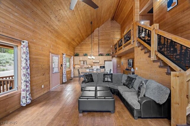 4830 Silver Tip Way, Mount Charleston, NV 89124 - living room with wooden ceiling, wood walls, healthy amount of natural light, high vaulted ceiling, and light wood-type flooring
