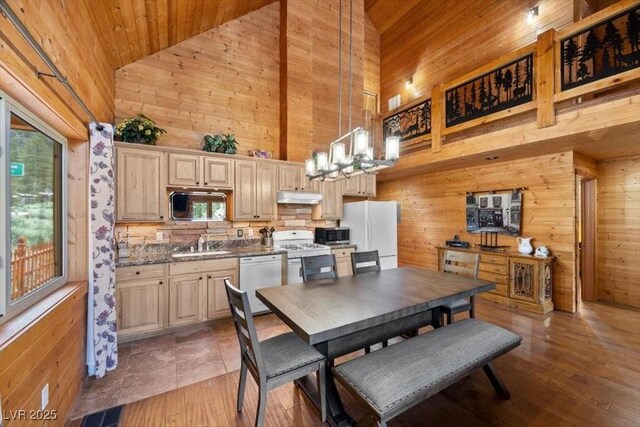4830 Silver Tip Way, Mount Charleston, NV 89124 - dining space with high vaulted ceiling, wooden walls, a chandelier, wooden ceiling, and light wood-style flooring