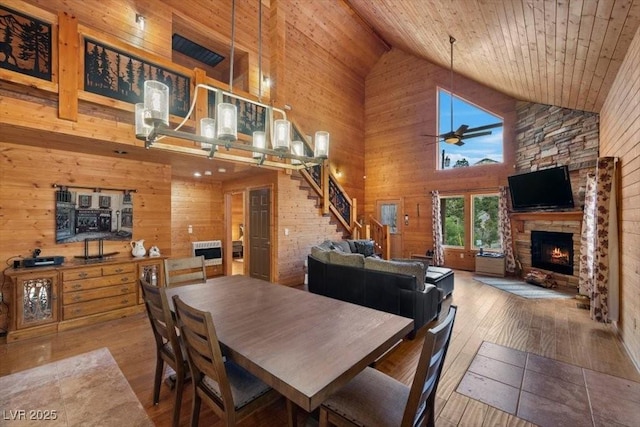 4830 Silver Tip Way, Mount Charleston, NV 89124 - dining room featuring high vaulted ceiling, a fireplace, wood walls, stairway, and hardwood / wood-style floors
