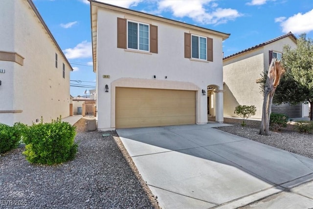 5667 Foxglove Field St, Las Vegas, NV 89130 - view of front facade with stucco siding, a garage, and concrete driveway