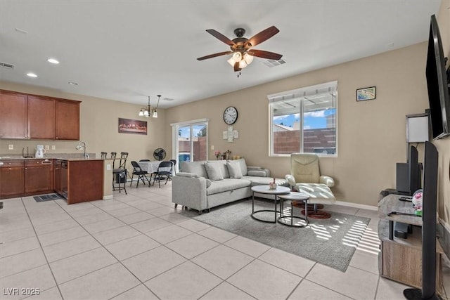 5667 Foxglove Field St, Las Vegas, NV 89130 - living room with light tile patterned floors, a ceiling fan, recessed lighting, baseboards, and a chandelier