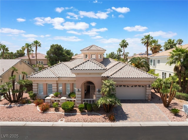 277 Dark Forest Ave, Las Vegas, NV 89123 - mediterranean / spanish house with an attached garage, a tiled roof, stucco siding, and driveway