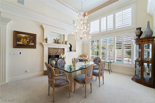 277 Dark Forest Ave, Las Vegas, NV 89123 - carpeted dining space with a high end fireplace, ornamental molding, a chandelier, and baseboards
