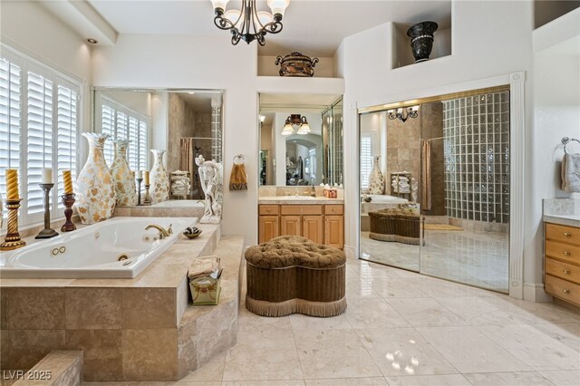 277 Dark Forest Ave, Las Vegas, NV 89123 - bathroom with vanity, a tub with jets, a stall shower, and healthy amount of natural light