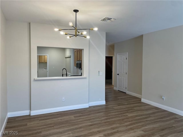 3161 Quail Song Dr Unit 3161, Laughlin, NV 89029 - kitchen with a chandelier, dark wood-type flooring, stainless steel microwave, baseboards, and hanging light fixtures