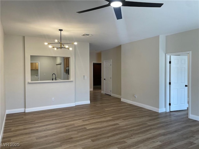 3161 Quail Song Dr Unit 3161, Laughlin, NV 89029 - unfurnished living room featuring a chandelier, wood finished floors, ceiling fan, and baseboards
