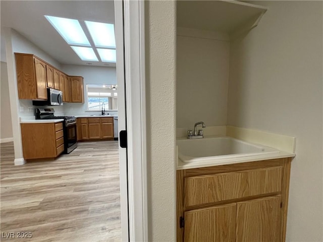 3161 Quail Song Dr Unit 3161, Laughlin, NV 89029 - bathroom with wood finished floors, a sink, a garden tub, and a skylight