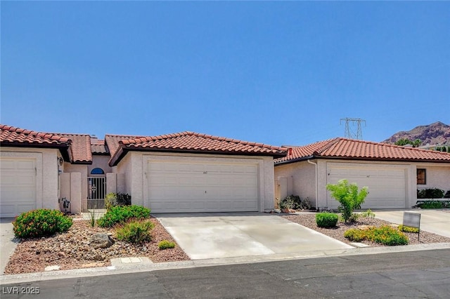 445 Intrepid Ct, Boulder City, NV 89005 - mediterranean / spanish-style home featuring stucco siding, an attached garage, and a tile roof