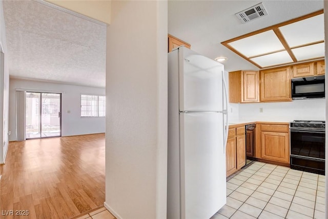 445 Intrepid Ct, Boulder City, NV 89005 - kitchen with black appliances, light countertops, open floor plan, and light tile patterned flooring