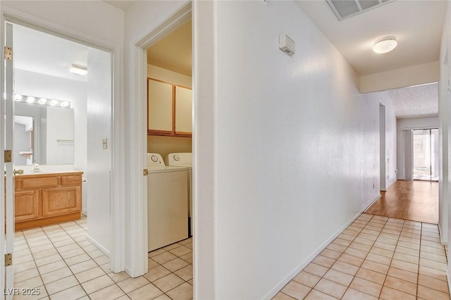 445 Intrepid Ct, Boulder City, NV 89005 - corridor with light tile patterned floors and independent washer and dryer