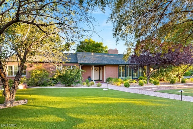 2001 Silver Ave, Las Vegas, NV 89102 - ranch-style house featuring a chimney, a front yard, and roof with shingles