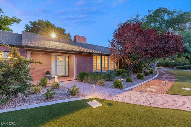 2001 Silver Ave, Las Vegas, NV 89102 - ranch-style house with a chimney, brick siding, and a front yard