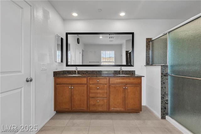 2832 Aragon Terrace Way, Henderson, NV 89044 - bathroom featuring double vanity, baseboards, tile patterned flooring, an enclosed shower, and recessed lighting