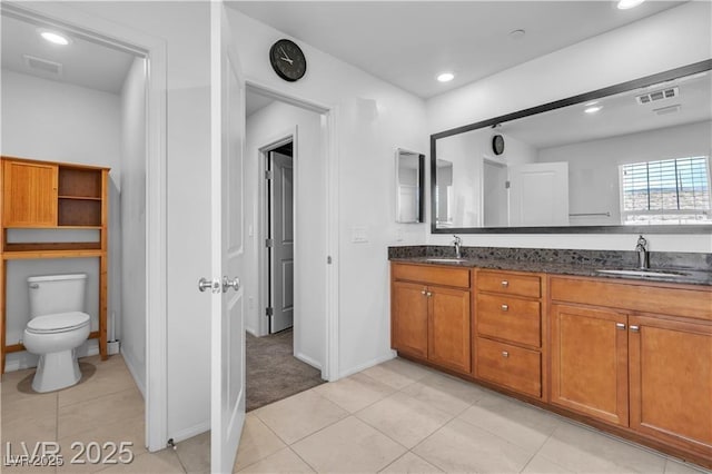 2832 Aragon Terrace Way, Henderson, NV 89044 - bathroom featuring double vanity, tile patterned floors, toilet, baseboards, and recessed lighting