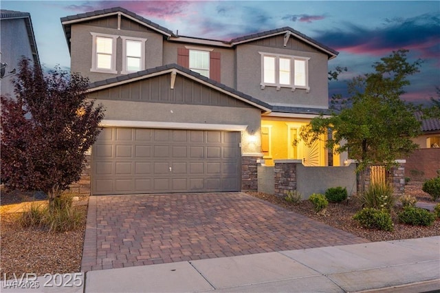 2832 Aragon Terrace Way, Henderson, NV 89044 - view of front of house featuring decorative driveway, stone siding, a tile roof, and a garage