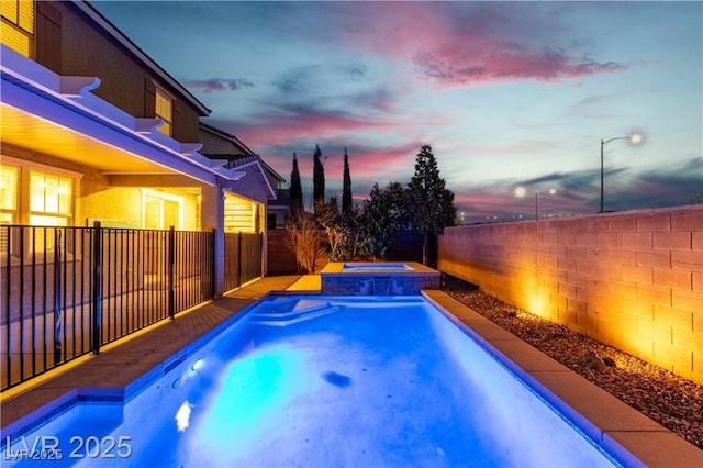2832 Aragon Terrace Way, Henderson, NV 89044 - pool at dusk featuring an in-ground hot tub and a fenced backyard