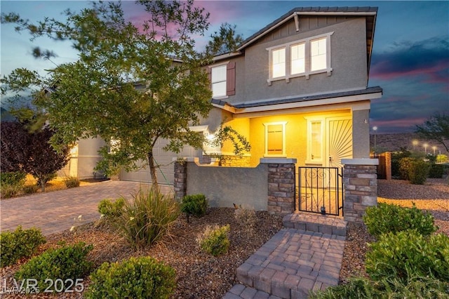 2832 Aragon Terrace Way, Henderson, NV 89044 - view of front facade with stucco siding, decorative driveway, and board and batten siding