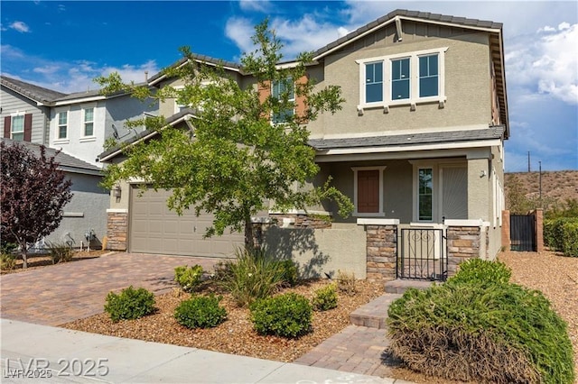 2832 Aragon Terrace Way, Henderson, NV 89044 - view of front of home featuring stone siding, stucco siding, decorative driveway, a gate, and a porch