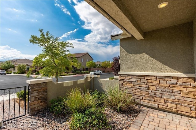 2832 Aragon Terrace Way, Henderson, NV 89044 - view of side of home featuring a residential view, stone siding, and stucco siding