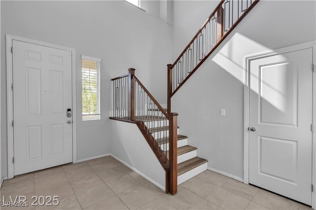 2832 Aragon Terrace Way, Henderson, NV 89044 - entrance foyer featuring stairs, light tile patterned floors, a high ceiling, and baseboards