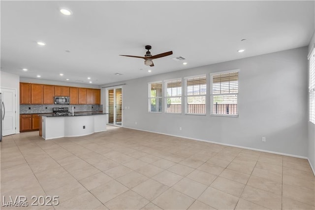 2832 Aragon Terrace Way, Henderson, NV 89044 - kitchen featuring stainless steel appliances, dark countertops, decorative backsplash, open floor plan, and recessed lighting