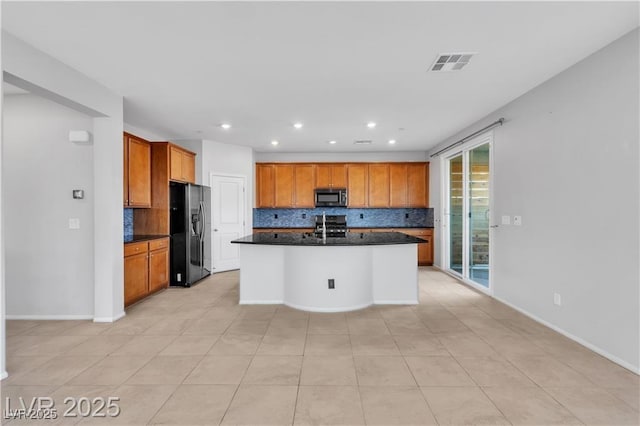 2832 Aragon Terrace Way, Henderson, NV 89044 - kitchen featuring appliances with stainless steel finishes, tasteful backsplash, dark countertops, recessed lighting, and a kitchen island with sink
