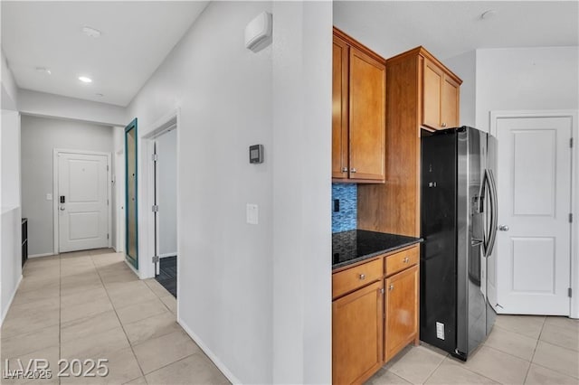 2832 Aragon Terrace Way, Henderson, NV 89044 - kitchen with stainless steel refrigerator with ice dispenser, light tile patterned floors, brown cabinets, decorative backsplash, and recessed lighting