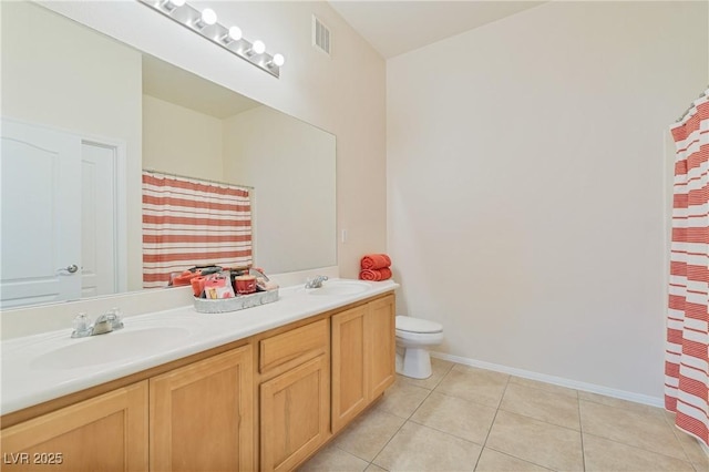 8985 S Durango Dr Unit 1177, Las Vegas, NV 89113 - bathroom with double vanity, toilet, tile patterned flooring, a shower with curtain, and baseboards