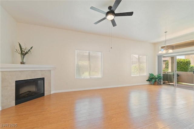 8985 S Durango Dr Unit 1177, Las Vegas, NV 89113 - living room with wood finished floors, a fireplace, a ceiling fan, baseboards, and a chandelier