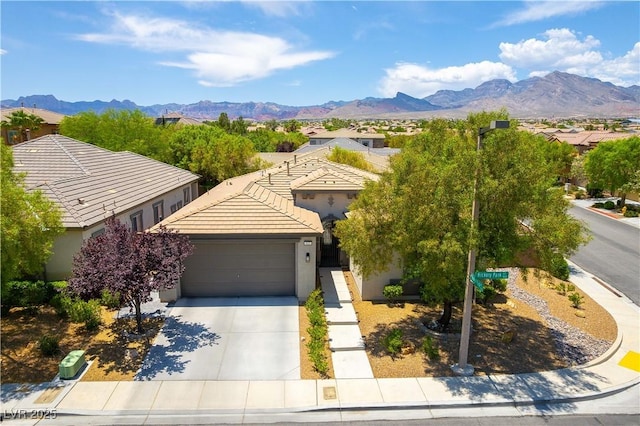 913 Hickory Park St, Las Vegas, NV 89138 - view of front facade featuring an attached garage, driveway, stucco siding, a mountain view, and a tile roof