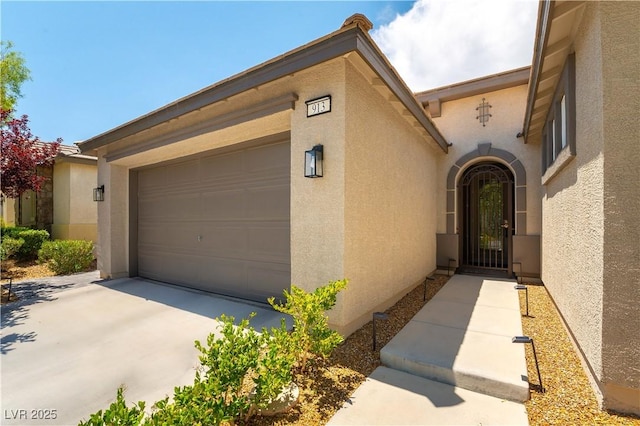 913 Hickory Park St, Las Vegas, NV 89138 - property entrance featuring stucco siding, driveway, and an attached garage