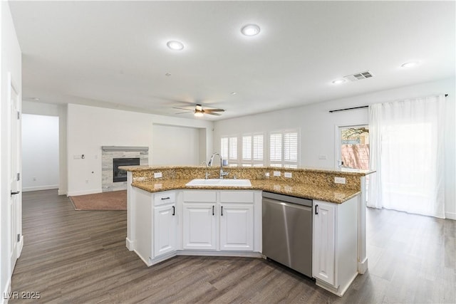 913 Hickory Park St, Las Vegas, NV 89138 - kitchen featuring stainless steel dishwasher, a ceiling fan, wood finished floors, a fireplace, and a kitchen island with sink