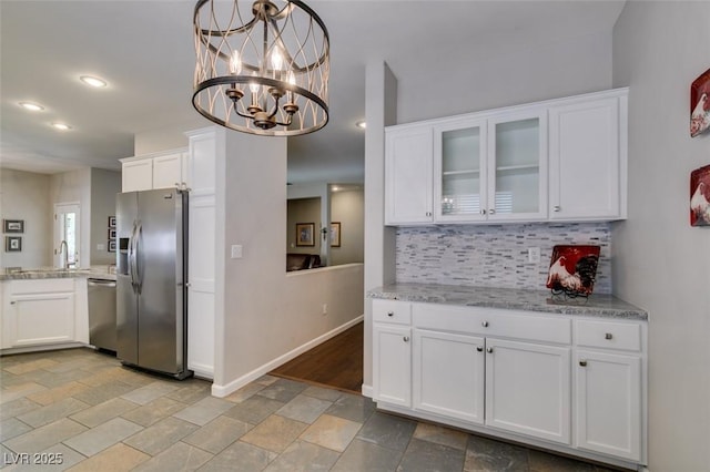 2111 Tiger Links Dr, Henderson, NV 89012 - kitchen with stainless steel appliances, stone tile flooring, tasteful backsplash, white cabinets, and glass insert cabinets