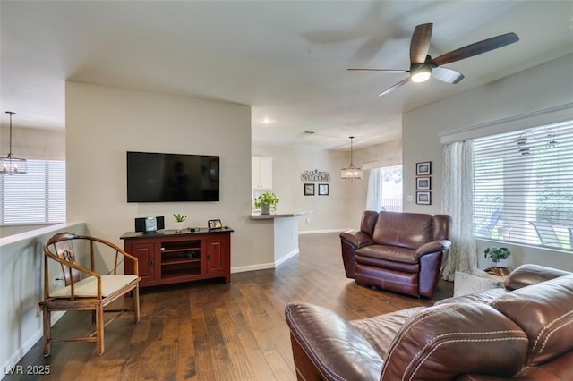 2111 Tiger Links Dr, Henderson, NV 89012 - living room with dark wood-style flooring, ceiling fan, baseboards, and a chandelier