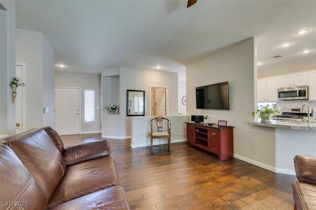 2111 Tiger Links Dr, Henderson, NV 89012 - living area with dark wood-style floors, recessed lighting, baseboards, and a ceiling fan