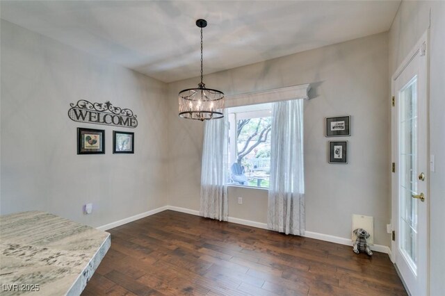 2111 Tiger Links Dr, Henderson, NV 89012 - unfurnished dining area with dark wood-style floors, a chandelier, and baseboards