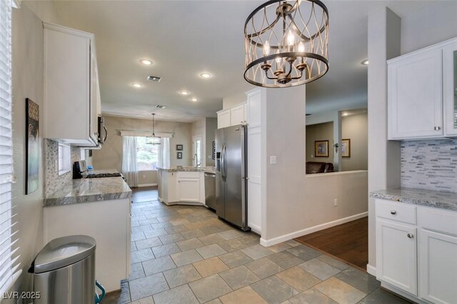 2111 Tiger Links Dr, Henderson, NV 89012 - kitchen with appliances with stainless steel finishes, decorative backsplash, stone tile floors, white cabinetry, and recessed lighting