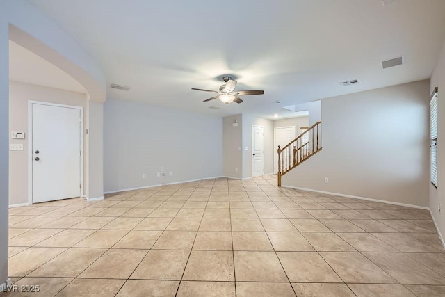 765 Jewel Tower St, Las Vegas, NV 89178 - spare room featuring a ceiling fan, stairway, baseboards, and light tile patterned floors